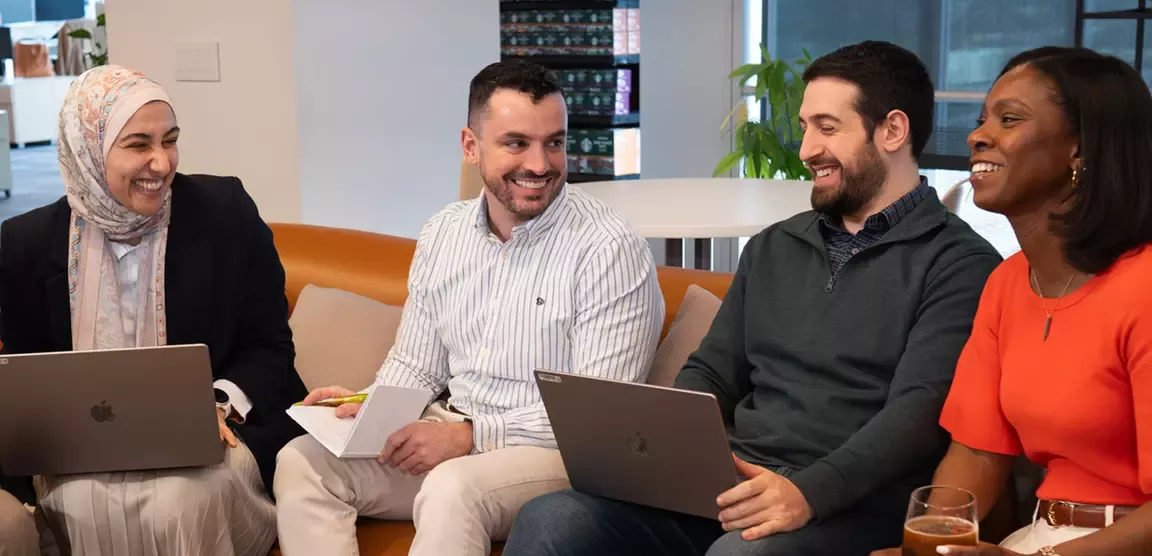 Employees working together on a couch