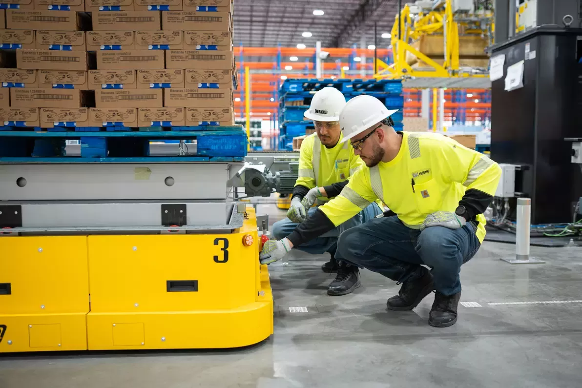Employees inspecting pallet