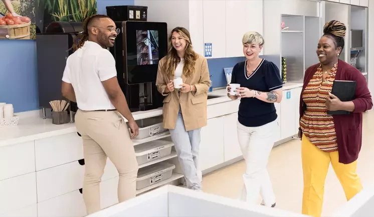 Colleagues chatting over coffee