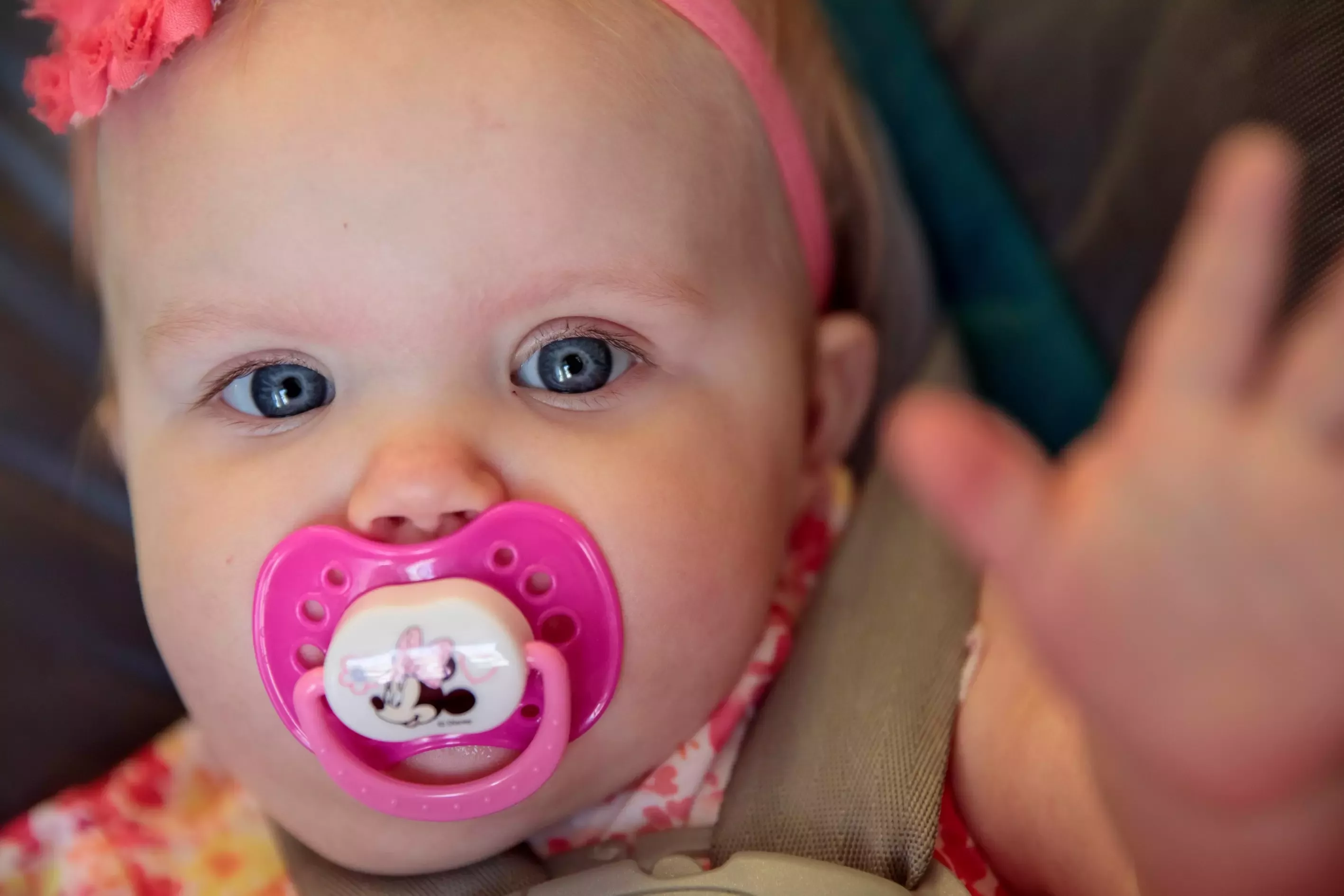 A baby reaches up towards the camera
