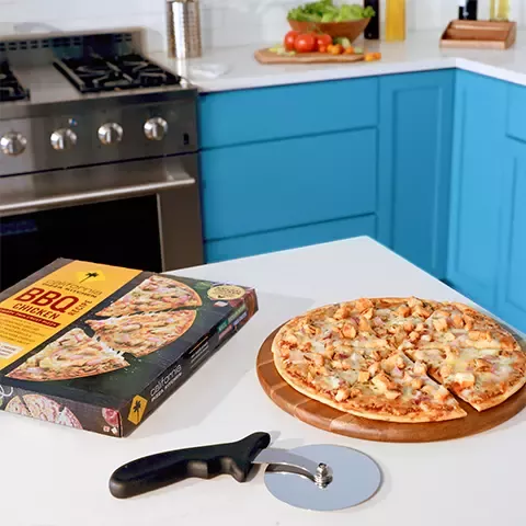 CPK Frozen BBQ Chicken Pizza on counter with pizza cutter