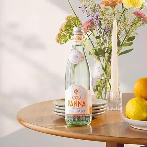 Acqua Panna water on table with lemons and flowers
