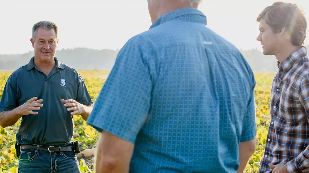 Three people on a farm
