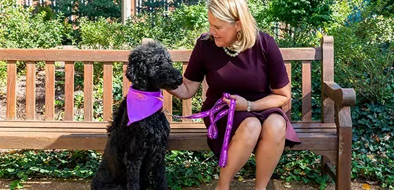 Nina Leigh Krueger, Purina President, with her dog.