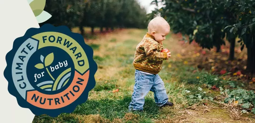 Baby walking in orchard